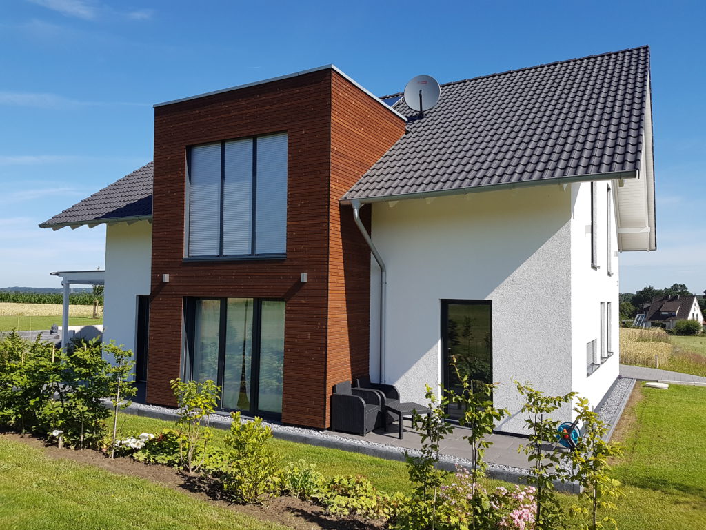 Ein moderner Klassiker mit klaren Linien - Dieses Einfamilienhaus mit Satteldach, weißer Putzfassade und schnörkelloser Architektur besitzt als Akzent einen Flachdach-Erker mit Lärchenholzverschalung.